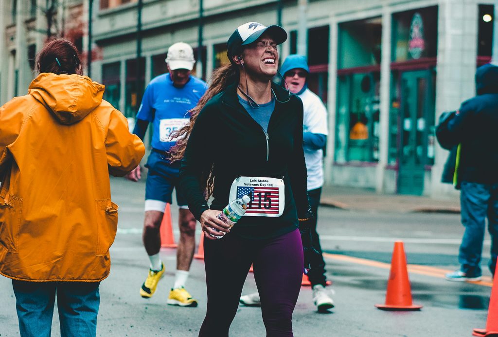 Marathon finisher rehydrating with electrolytes post-race.