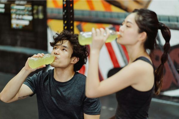 Two runners hydrate during a marathon