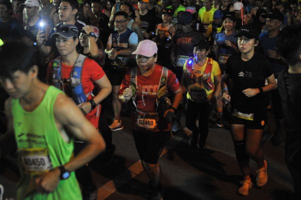 Determined marathon runners in a run with with focus during the last stretch of the Borneo Marathon