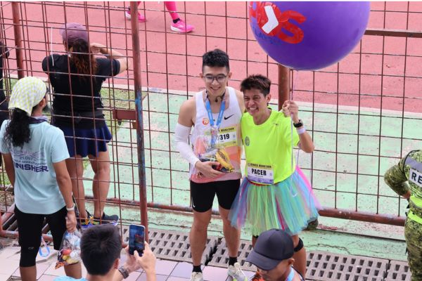Runners happily recieve medals at the finish line