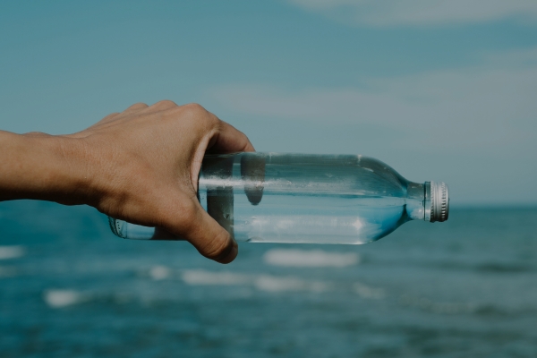 Hand holding a water bottle.