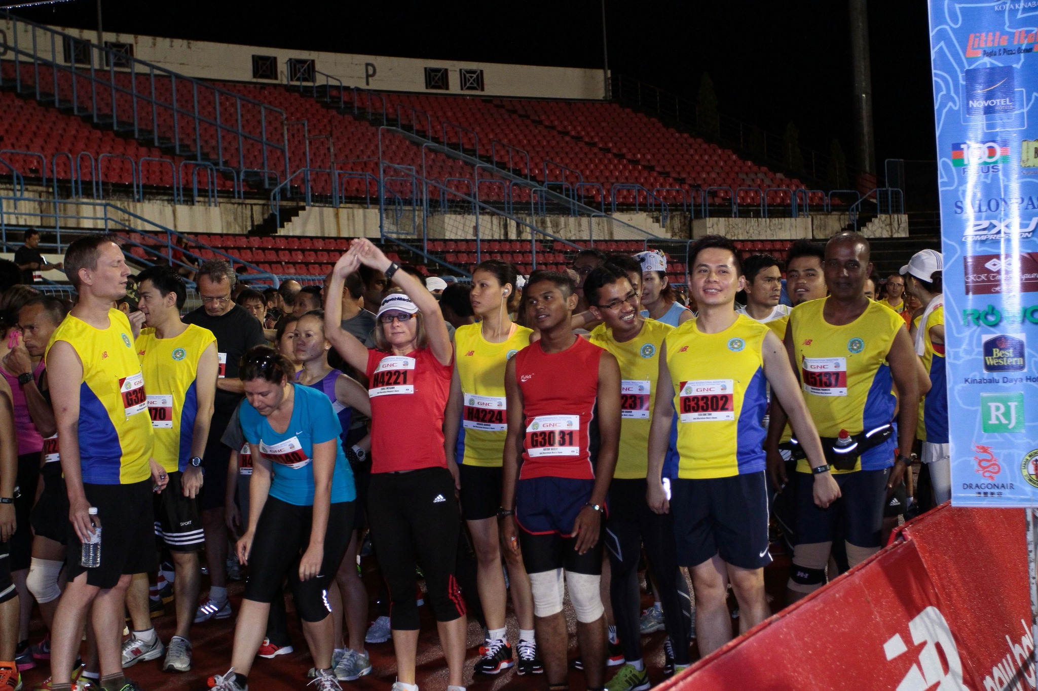 A group of runners gathered at the starting line of the Borneo International Marathon.