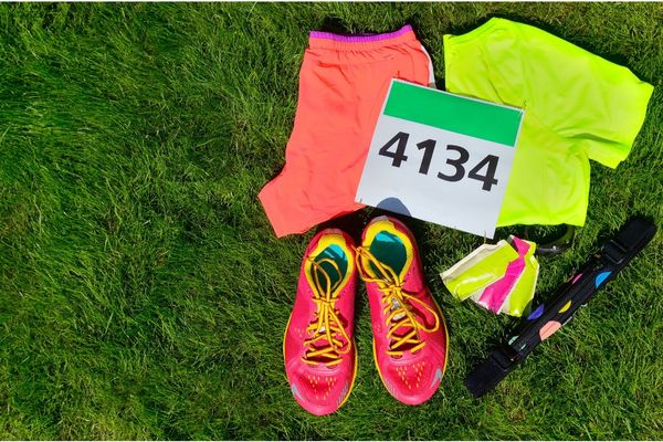 A runner packing their race day essentials into a bag.