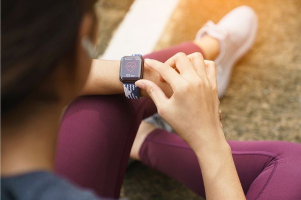 A runner monitoring their condition for signs of heat stress during the race.