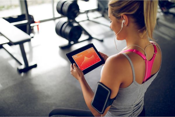  A runner reviewing running stats on a laptop.