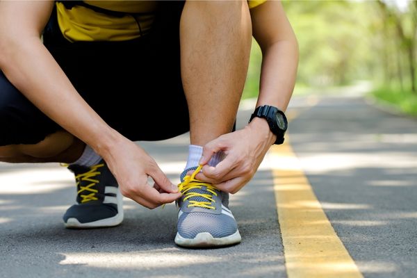 Runner tying shoelaces before a race.