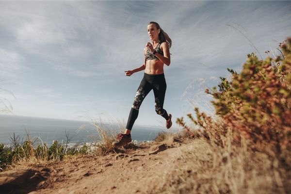 A runner performing hill sprints as part of uphill running training.
